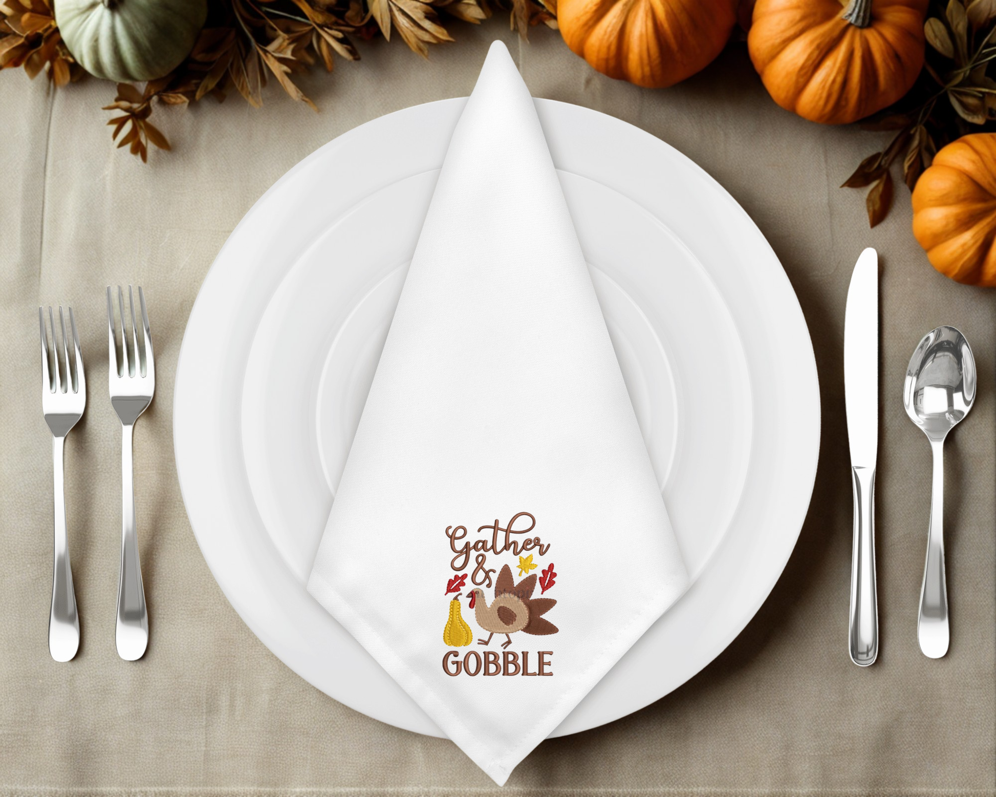 Thanksgiving table setting with a leaf-shaped napkin featuring text and graphics.